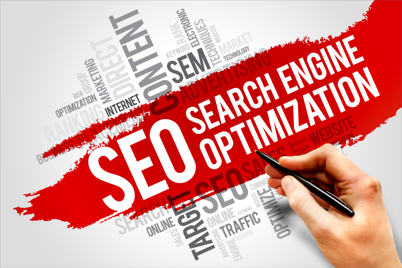 A person writing the words search engine optimization with a pen