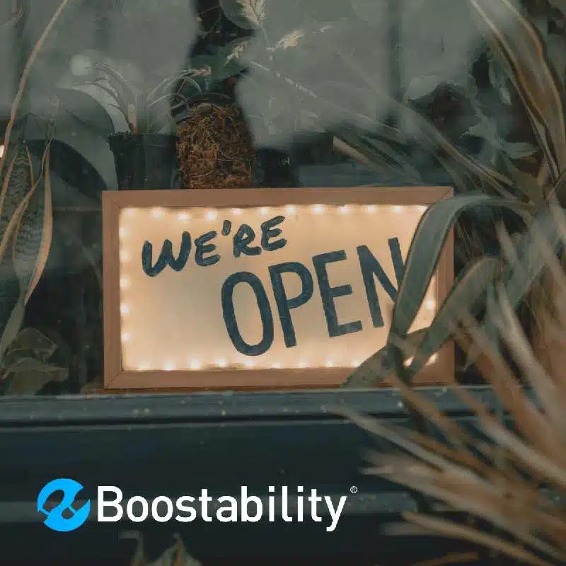 Close up of an open sign on the door at a shop of a small business