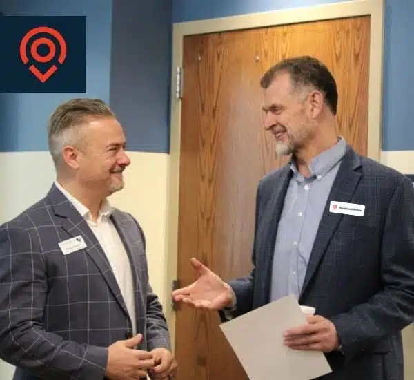 Local online marketing agency speaks with a stakeholder at an event