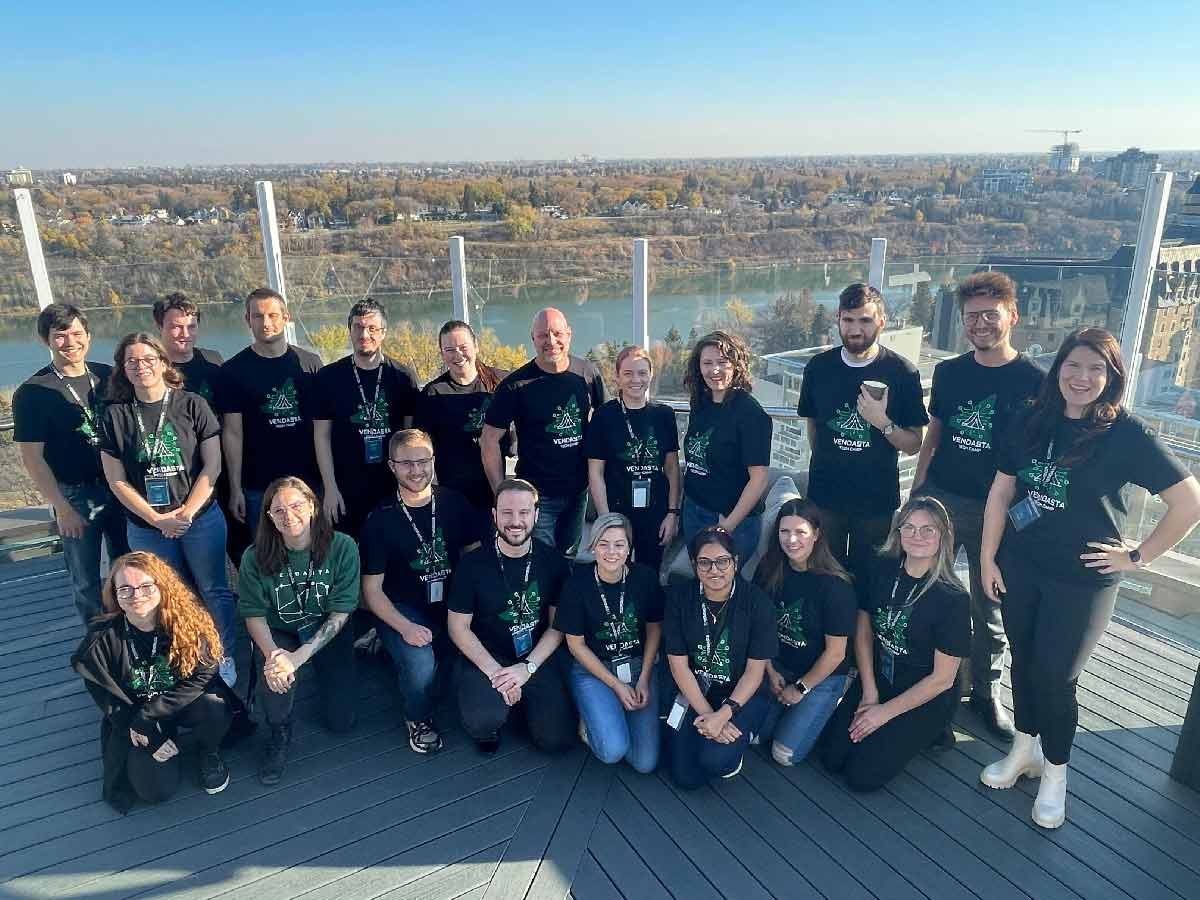 Team of Vendasta employees that volunteered for the Tech camp, posing on the rooftop patio overlooking the South Saskatchewan river.